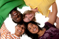 kids looking down at the camera on the floor while touching heads